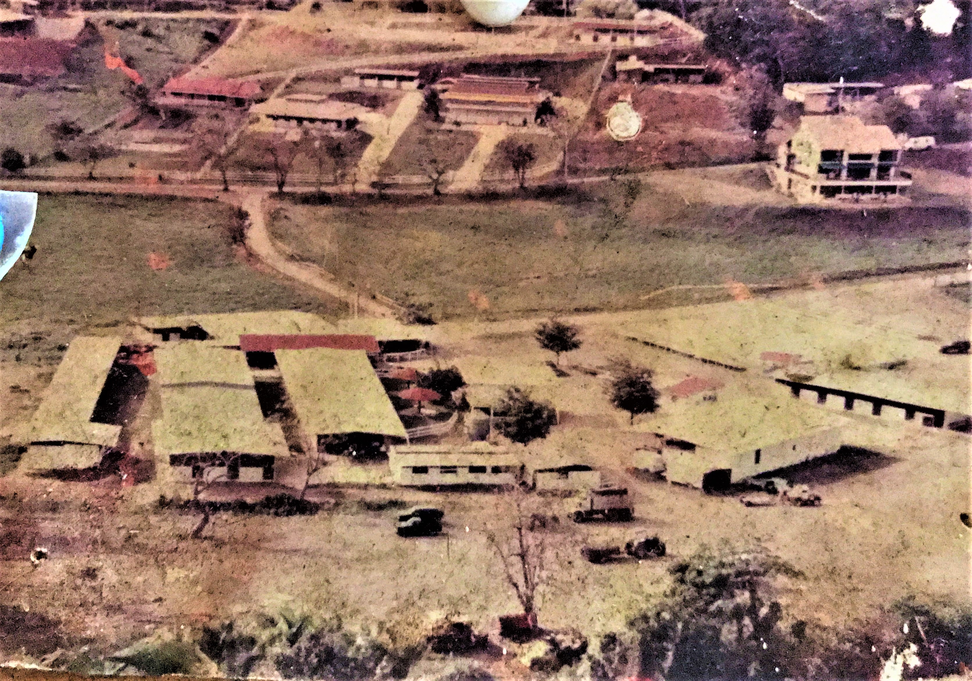 Aerial view of farm buildings and surrounding fields.