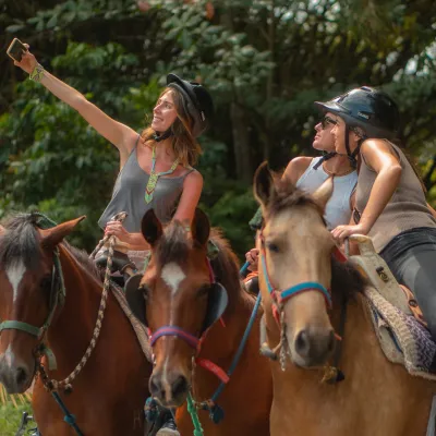 a couple of people that are sitting on a horse